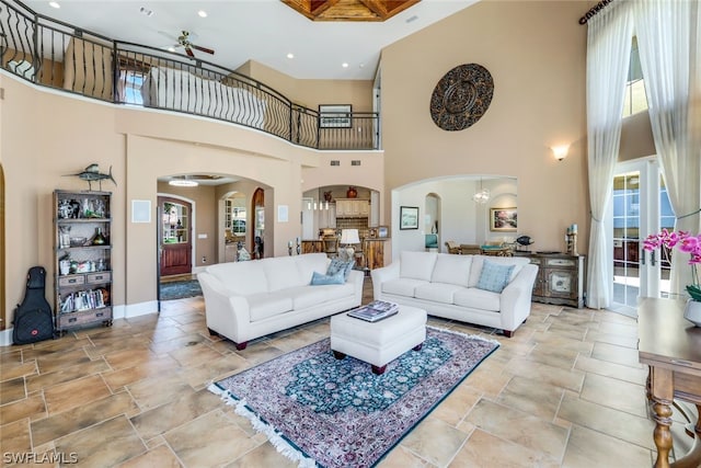 living room featuring a high ceiling and ceiling fan