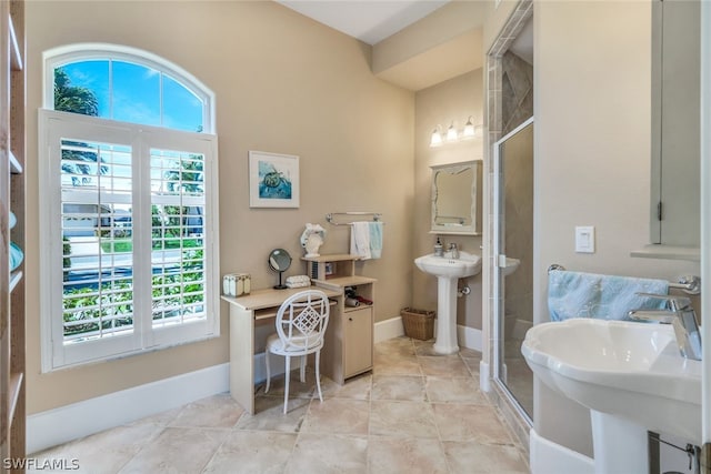 bathroom featuring an enclosed shower, tile patterned floors, and sink