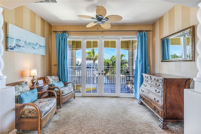 sitting room with ceiling fan, french doors, and carpet