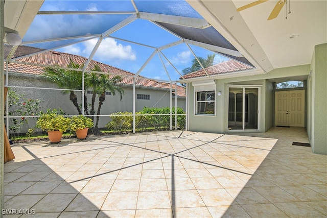 unfurnished sunroom with ceiling fan