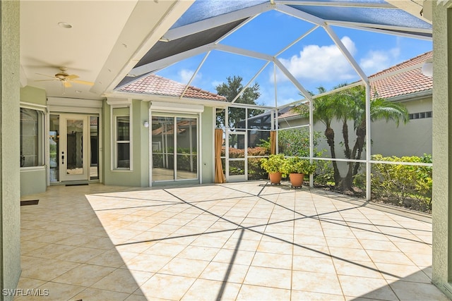 unfurnished sunroom featuring ceiling fan