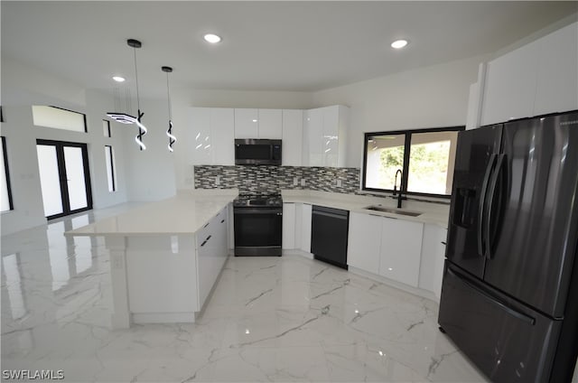 kitchen with tasteful backsplash, pendant lighting, black appliances, light tile floors, and sink