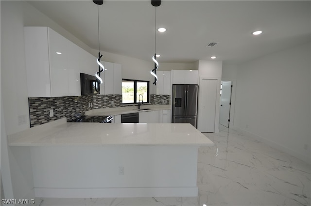 kitchen with hanging light fixtures, black appliances, sink, tasteful backsplash, and light tile flooring