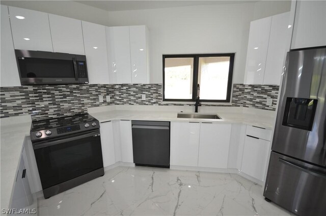 kitchen featuring white cabinets, backsplash, and appliances with stainless steel finishes