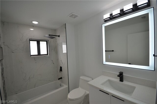 full bathroom with tiled shower / bath, toilet, and vanity