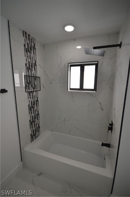 bathroom featuring tile floors and tiled shower / bath