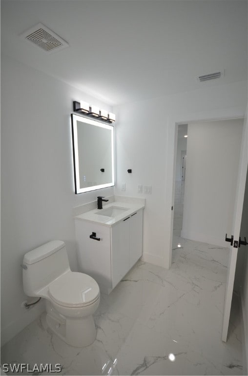 bathroom featuring vanity, toilet, and tile floors