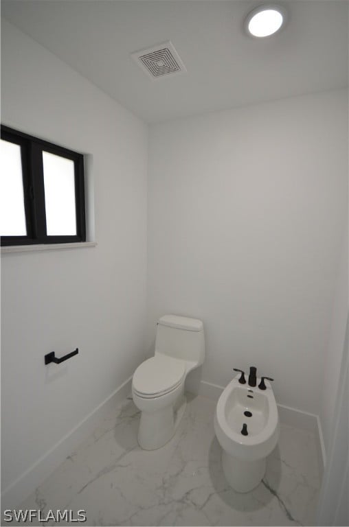 bathroom featuring a bidet and toilet