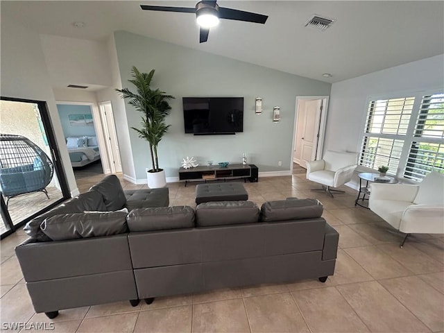 tiled living room with ceiling fan and lofted ceiling