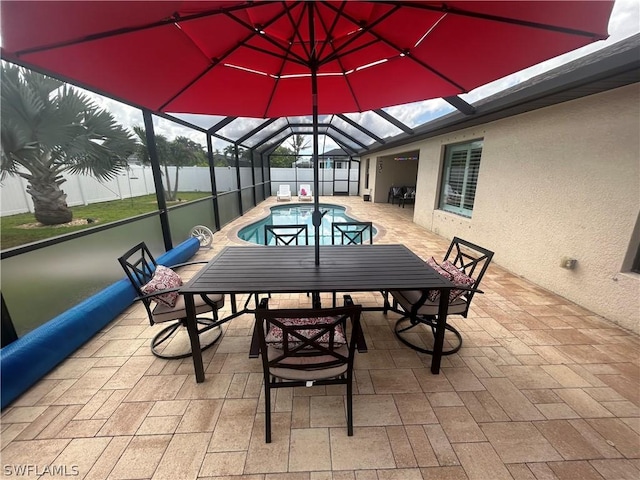 view of patio with a fenced in pool and glass enclosure