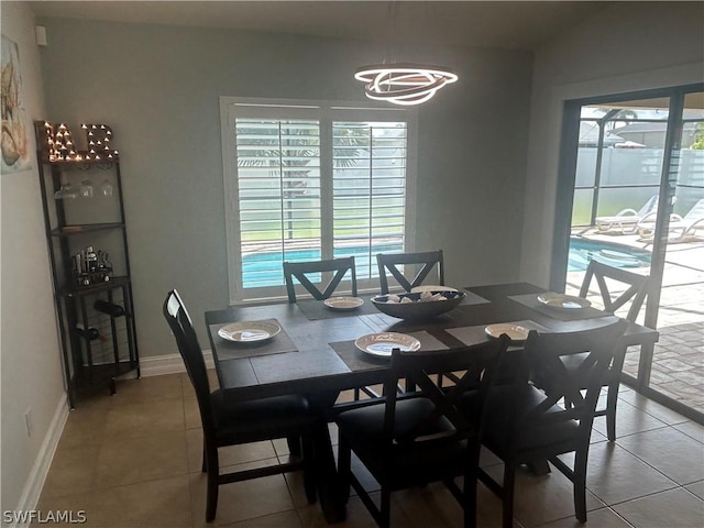 dining space with a chandelier and tile patterned floors