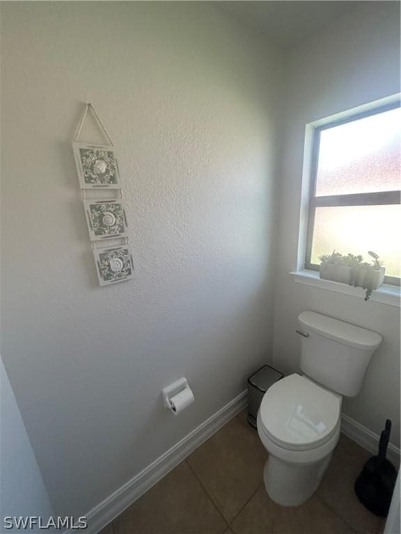 bathroom with tile patterned floors and toilet