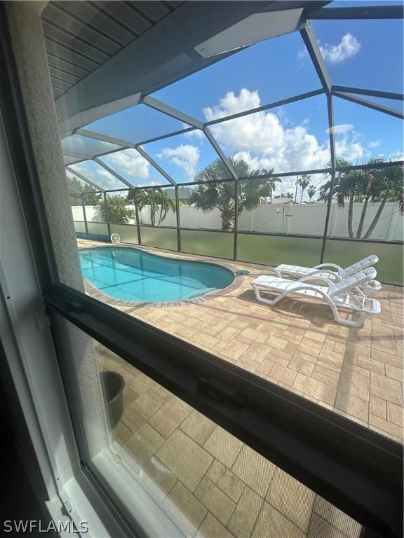 view of swimming pool with a lanai and a patio