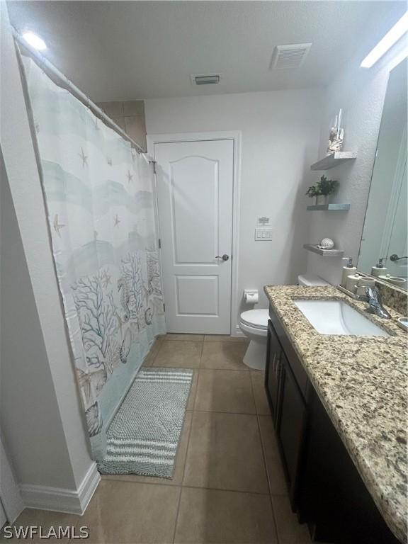 bathroom featuring tile patterned floors, vanity, toilet, and a shower with shower curtain