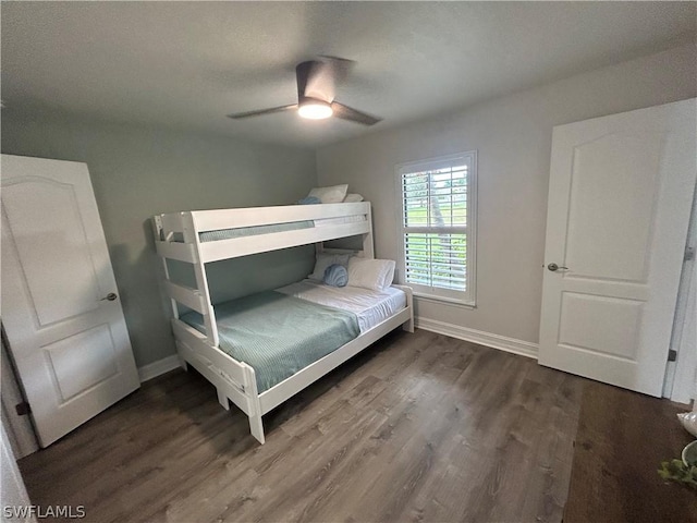 bedroom with ceiling fan and dark hardwood / wood-style flooring