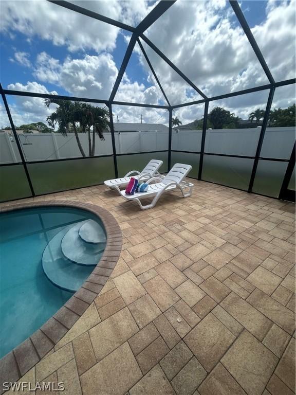 view of patio / terrace featuring a fenced in pool and a lanai