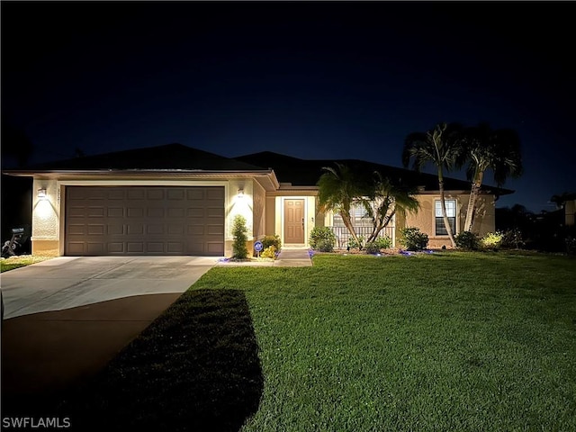 ranch-style home with a garage and a yard