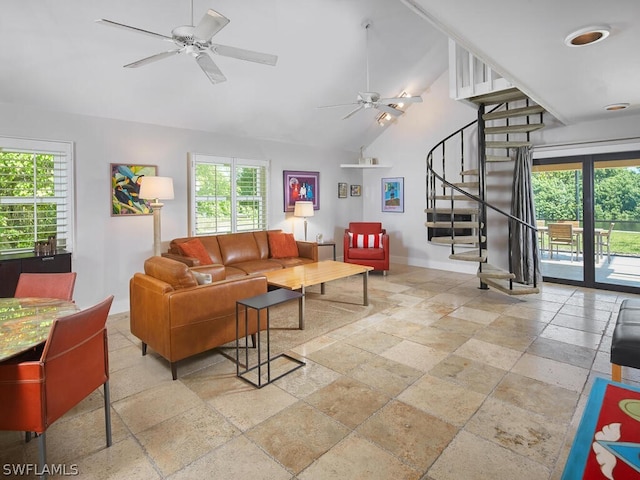 living room with ceiling fan, a healthy amount of sunlight, and vaulted ceiling