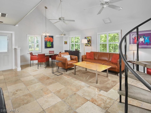 living room with high vaulted ceiling and ceiling fan with notable chandelier