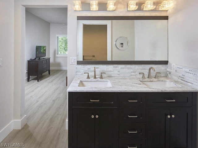 bathroom with tasteful backsplash, vanity, and hardwood / wood-style floors