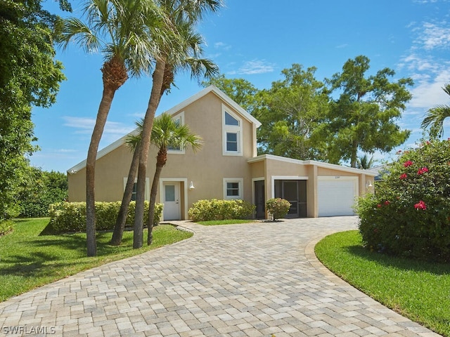 view of front facade with a front yard and a garage