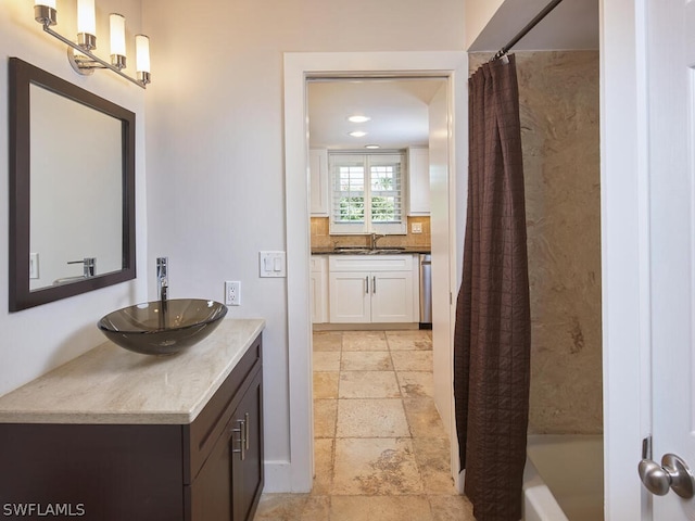 bathroom featuring shower / bathtub combination with curtain, backsplash, and vanity