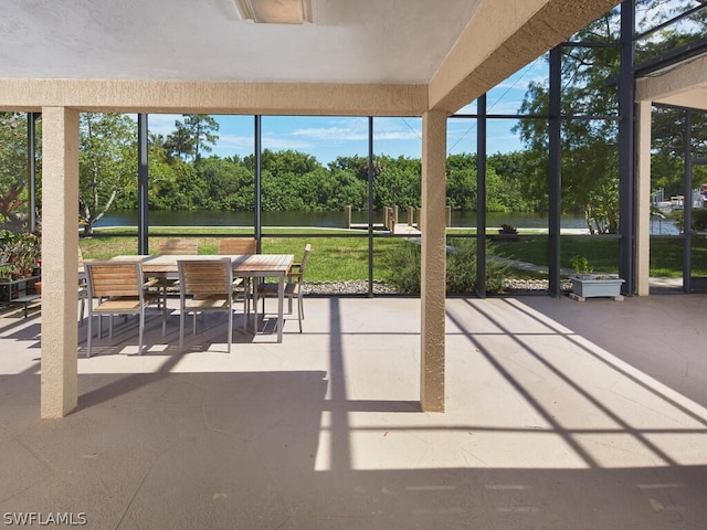 sunroom featuring a healthy amount of sunlight and a water view