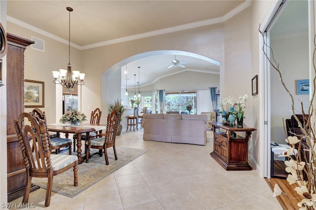 dining area with ornamental molding, vaulted ceiling, ceiling fan with notable chandelier, and light tile patterned floors