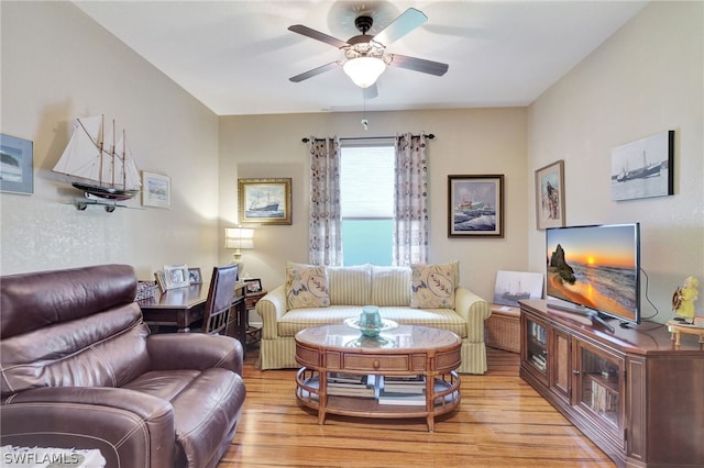 living room featuring light wood-type flooring and ceiling fan