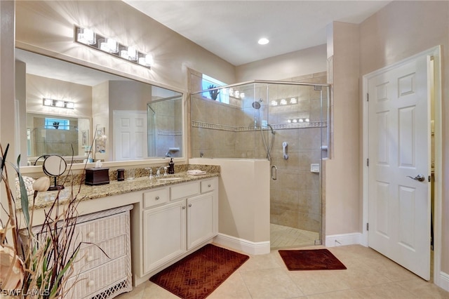 bathroom featuring vanity, an enclosed shower, and tile patterned floors