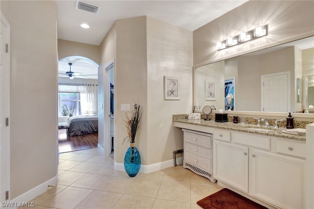 bathroom with tile patterned flooring, vanity, and ceiling fan