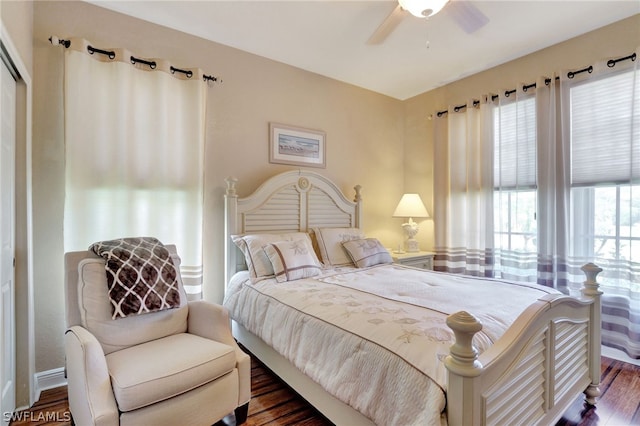 bedroom with ceiling fan and dark hardwood / wood-style flooring