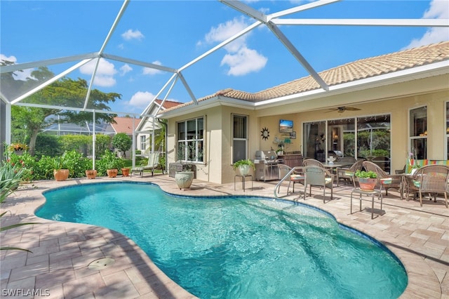 view of pool featuring a lanai, area for grilling, a patio area, and ceiling fan