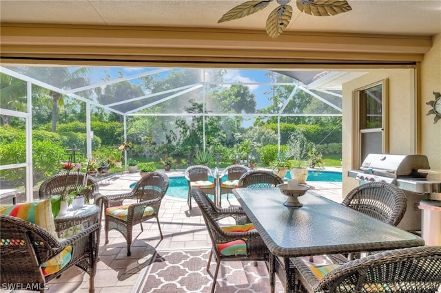 view of patio featuring glass enclosure and ceiling fan