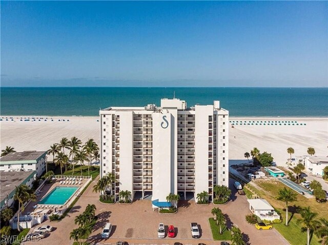 birds eye view of property with a view of the beach and a water view