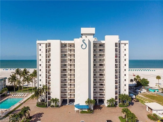 view of property with a beach view and a water view