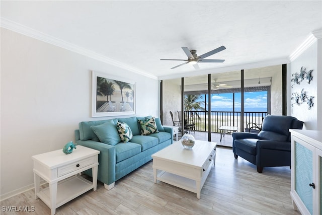 living room featuring light hardwood / wood-style flooring, ornamental molding, a wall of windows, ceiling fan, and a water view