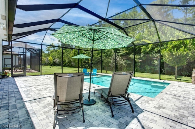 view of swimming pool featuring a lanai, a lawn, and a patio