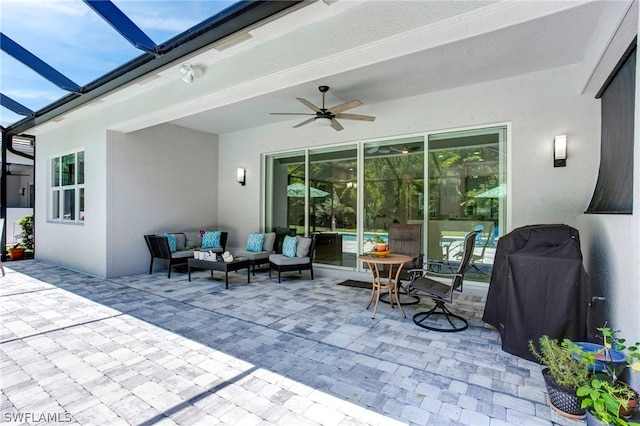 view of patio / terrace featuring ceiling fan, a grill, a lanai, and an outdoor living space