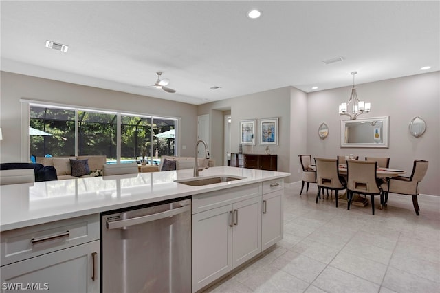 kitchen with white cabinets, ceiling fan with notable chandelier, sink, stainless steel dishwasher, and decorative light fixtures