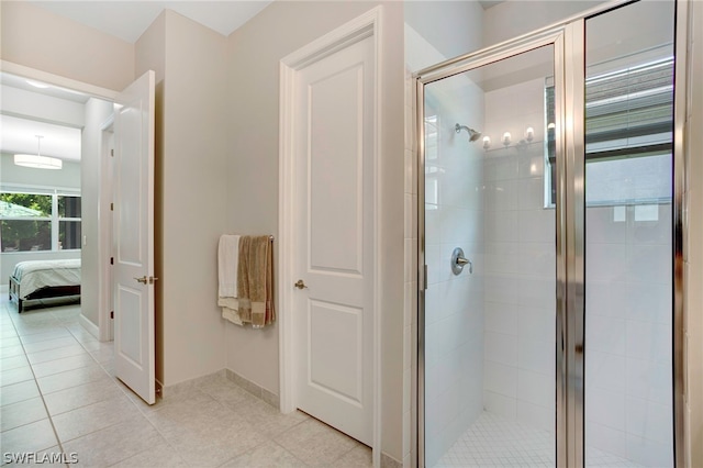 bathroom with tile patterned flooring and walk in shower