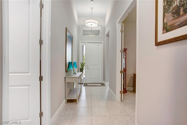 hall with light tile patterned floors