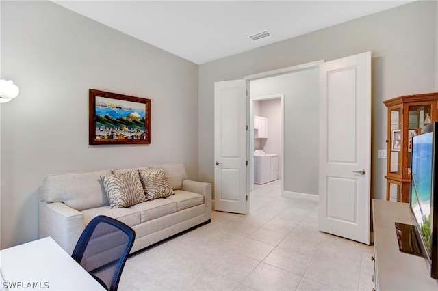 tiled living room featuring washer / clothes dryer