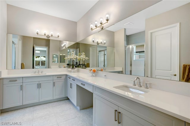 bathroom featuring tile patterned floors, vanity, and a shower with shower door