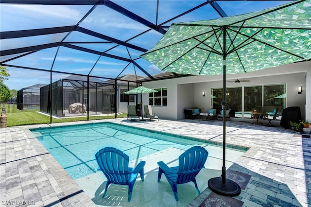 view of pool featuring ceiling fan, a lanai, and a patio