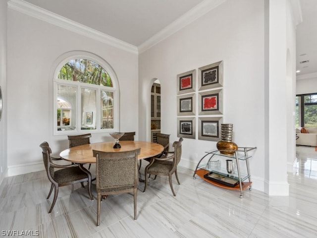 dining space with crown molding and a wealth of natural light