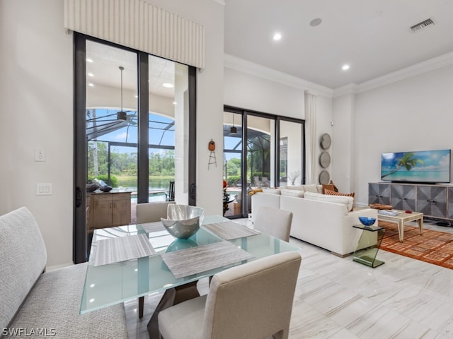 dining room featuring plenty of natural light and ornamental molding