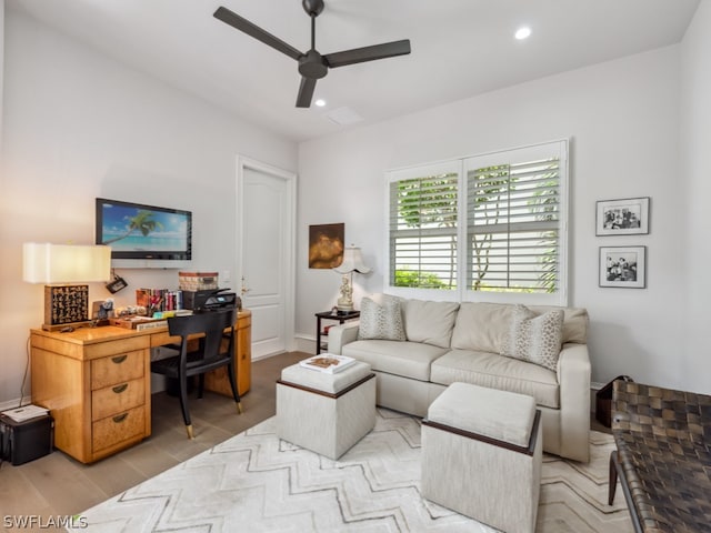 living room with ceiling fan and light hardwood / wood-style flooring