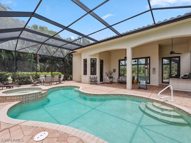 view of swimming pool featuring a lanai, a patio area, ceiling fan, and an in ground hot tub