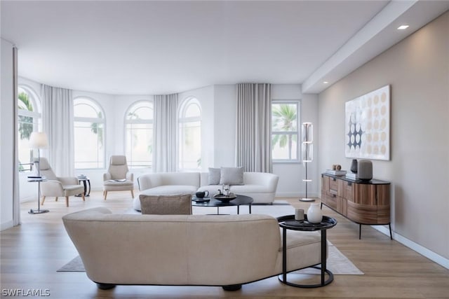 living area featuring light wood-style floors, baseboards, and recessed lighting